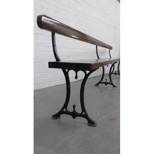 224 - Early 20th century stained pine pew / bench with black iron supports, 330 x 73 x 28cm