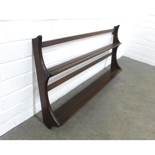 240 - An Ercol dark elm wall plate rack, 97 x 50cm.