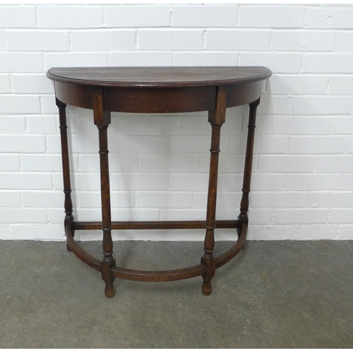 254 - Early 20th century oak demi lune table, 77 x 72 x 37cm.