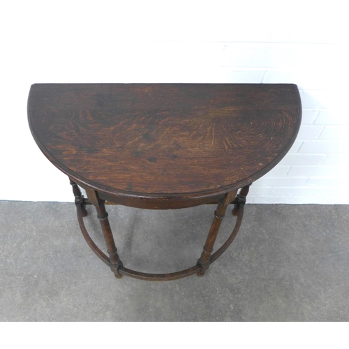 254 - Early 20th century oak demi lune table, 77 x 72 x 37cm.