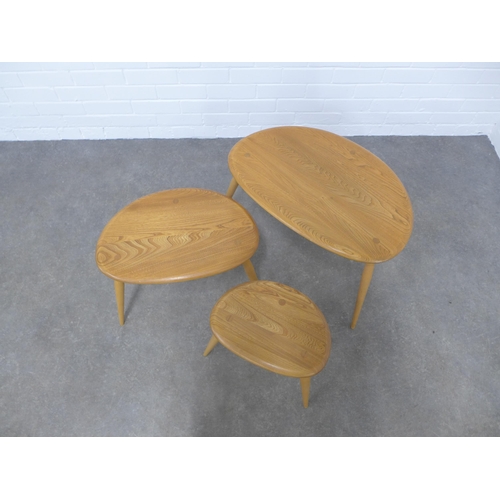 257 - An Ercol light elm nest of three Pebble tables , 65 x 41 x 43cm.