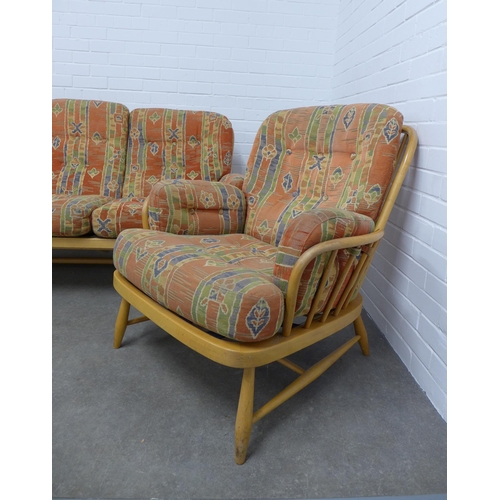 282 - An Ercol light elm Windsor three piece suite, with loose cushions, 195 x 82 x 56cm.