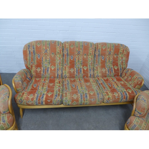 282 - An Ercol light elm Windsor three piece suite, with loose cushions, 195 x 82 x 56cm.