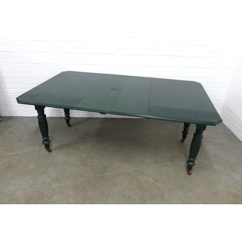 285 - Green painted kitchen drop leaf table,  extending, on baluster legs with castors,  181 x 76 x 106cm.