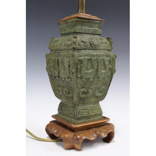 342 - Chinese archaic bronze style table lamp, with wooden mounts and base, 56cm high