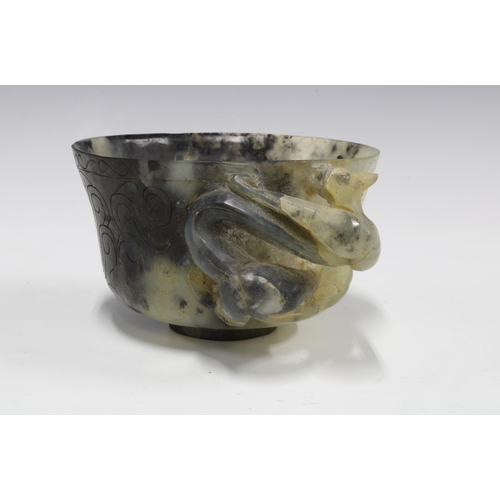 346 - Chinese carved hardstone cup with a dragon handle, standing on a plain circular footrim, 12cm diamet... 