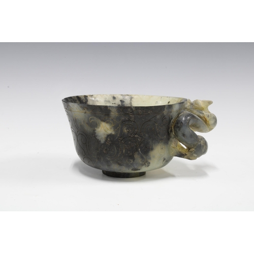 346 - Chinese carved hardstone cup with a dragon handle, standing on a plain circular footrim, 12cm diamet... 