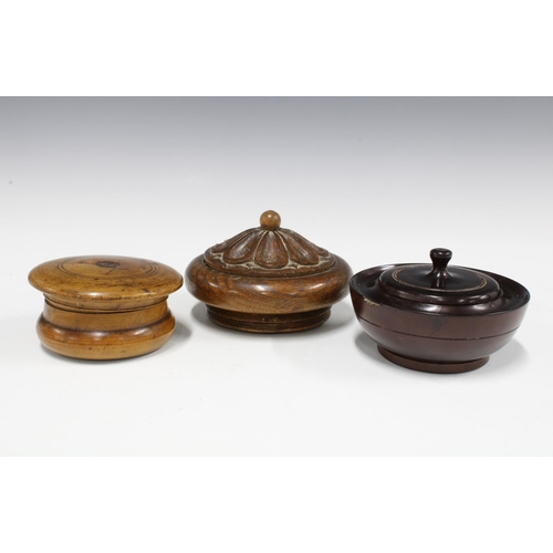 358 - Treen shaving soap pot, the lid with internal mirror, together with an ebony lidded pot and an oak b... 