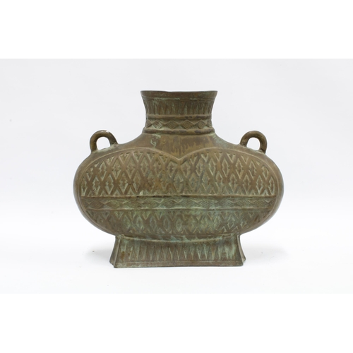 372 - Large bronze archaic style vase with hatched pattern and loop handles, open base with shaped hardwoo... 