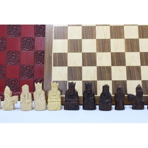 394 - 'Lewis' resin chess set with red board together with a walnut and  maple chess board (a lot)