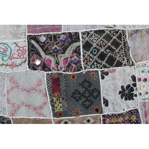 410 - Patchwork quilt, with some crewelwork and embroidered panels, and mirror applique, 155 x 100cm