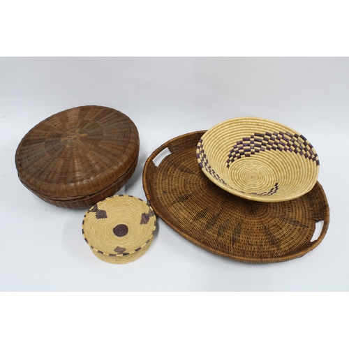 421 - A woven tray, 47 x 48cm, together with three African woven baskets (4)