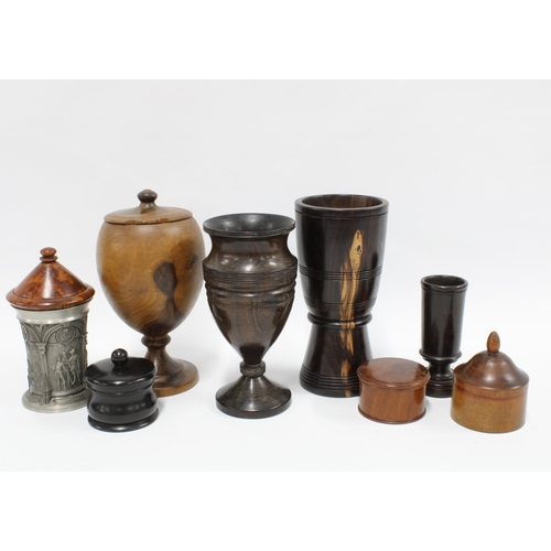 424 - A collection of treen to include a lidded ebony pot, large covered cup, dressing table hat pin holde... 