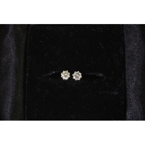 45 - A pair of diamond stud earrings, mounted in unmarked white metal, approx 0.20ct