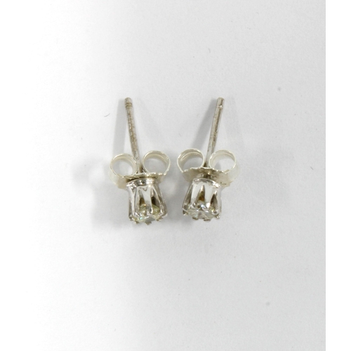 45 - A pair of diamond stud earrings, mounted in unmarked white metal, approx 0.20ct