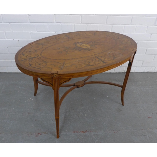 452 - Mahogany and satinwood inlaid oval table, on tapering slender legs with stretcher, 89 x 51 x 56cm.