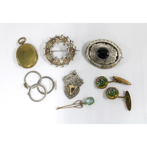52 - A collection of white metal brooches, a silver ring in three parts, stamped 900 and a pair of thistl... 