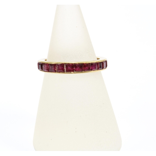 61 - A gold and ruby full eternity ring, size N