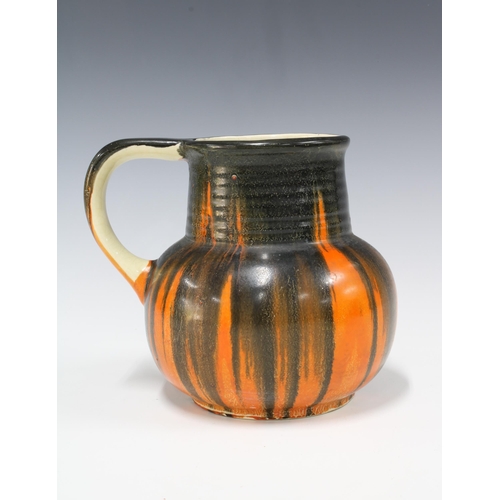 87 - Early 20th century Trent pottery jug with orange and black drip pattern, 16 x 18cm.