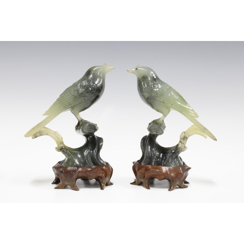 131 - Pair of carved jadeite birds on wooden stands, 15cm (2)