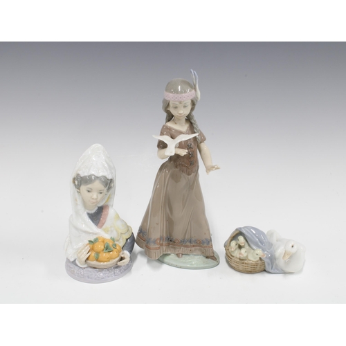 134 - Three Lladro figures,  including American Love 6153, Valencian Harvest 5668 and another, tallest 20c... 