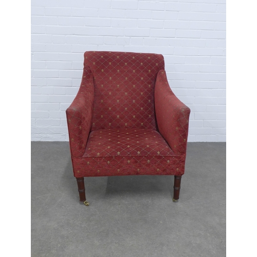 219 - An upholstered armchair, on mahogany legs with brass caps and castors, 71 x 89 x 49cm.