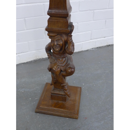 249 - Carved oak and fruitwood table/stand, on a  Jester figural column, 32 x 64cm.