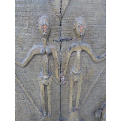 275 - An African carved door on stand, 68 x 144cm.