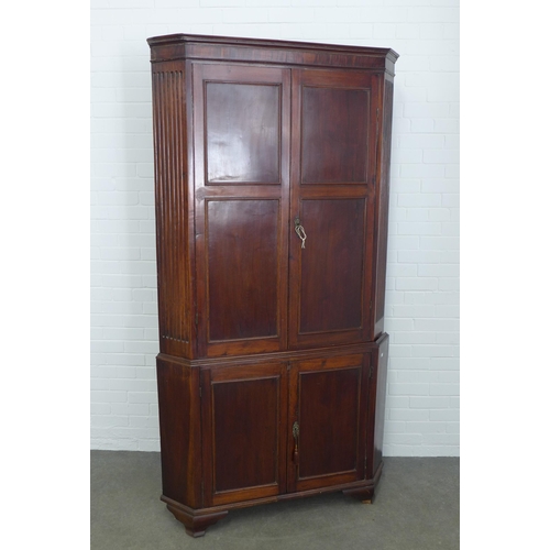 283 - Mahogany corner cupboard, floor standing and of large proportions, with painted shelves to the inter... 