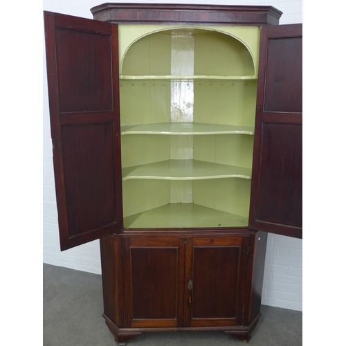 283 - Mahogany corner cupboard, floor standing and of large proportions, with painted shelves to the inter... 