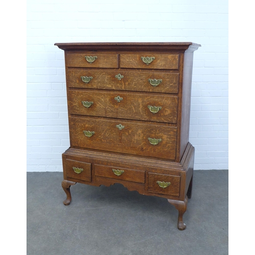 286 - An oak chest on stand, the top with two short and three graduating long drawers, the base with three... 