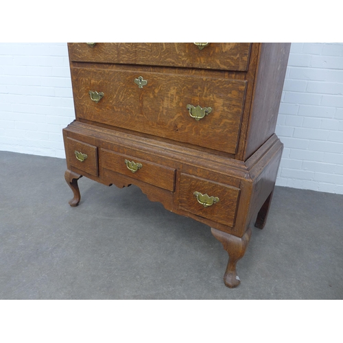 286 - An oak chest on stand, the top with two short and three graduating long drawers, the base with three... 