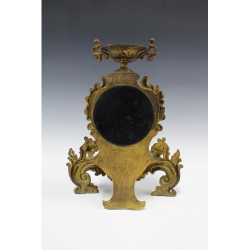 331 - A French brass cased mantle clock, with an urn surmount over a circular dial within a rococo style c... 