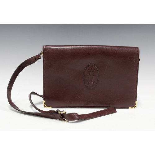 392 - Maroon leather handbag with a Cartier logo, 28 x 19cm