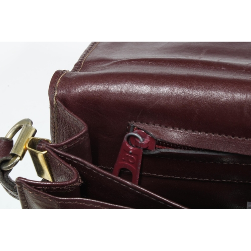 392 - Maroon leather handbag with a Cartier logo, 28 x 19cm