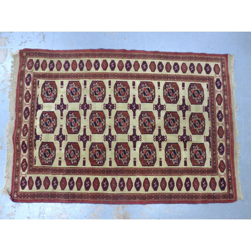 403 - Bokhara style rug, beige field with three rows of seven guks, 175 x 128cm.