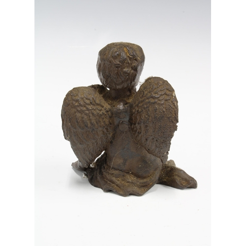 414 - Bronze patinated metal figure of a seated cherub, 13cm