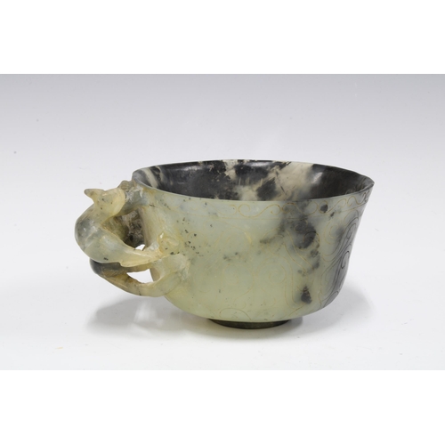 420 - Chinese carved hardstone cup with a dragon handle, standing on a plain circular footrim, 12cm diamet... 