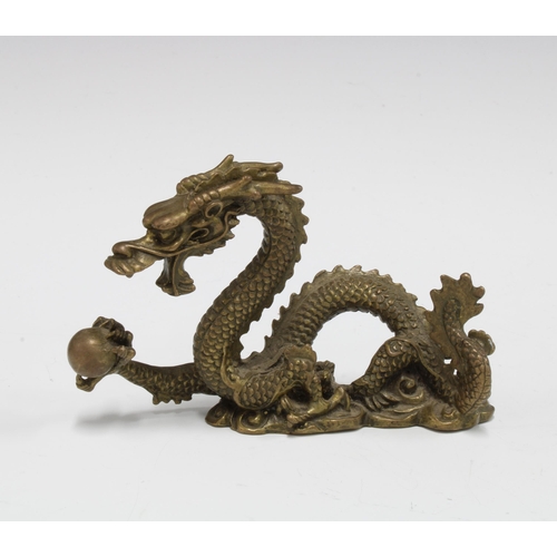 422 - A bronze dragon and pearl of wisdom figure, 12cm long