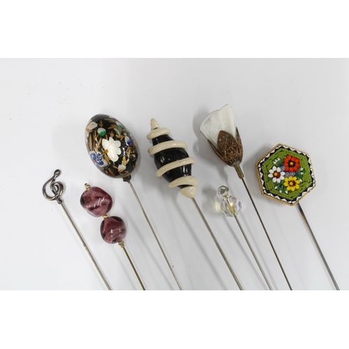 424 - Porcelain hat pin holder with a selection of hatpins to include a Charles Horner Sterling silver exa... 