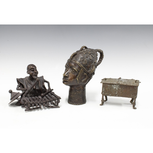 429 - Benin bronze head, 18cm high, a small bronze table casket and a bronze figure of a musician playing ... 