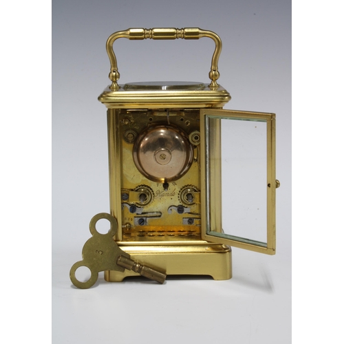 434 - A small brass and glass panelled carriage clock (one glass side panel lacking) , full striking, with... 