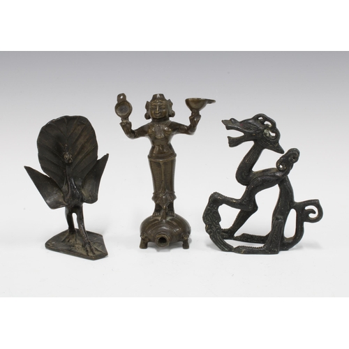 438 - Three Indian bronze figures to include a deity and a peacock, etc , tallest 12cm (3)