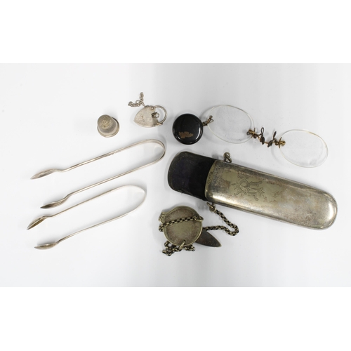 58 - Two silver sugar tongs, silver thimble, silver heart padlock and an Epns chatelaine spectacles case ... 