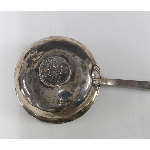 59 - Georgian unmarked white metal toddy ladle, the bowl inset with a coin, baleen handle, 39cm long