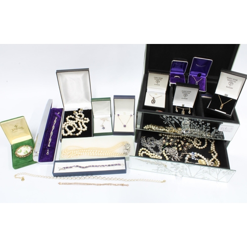 71A - A mirrored glass jewellery box containing a collection of silver and costume jewellery together with... 
