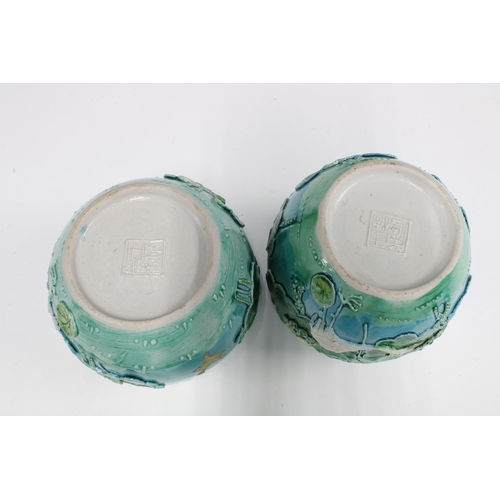 99 - Pair of Chinese relief glazed jars in the Wang Bing Rong style, decorated vases with cranes and wate... 