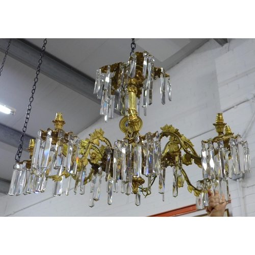 452 - Gilt metal eight branch chandelier, decorated in grape leaves, with glass drops, approximately 50 x ... 