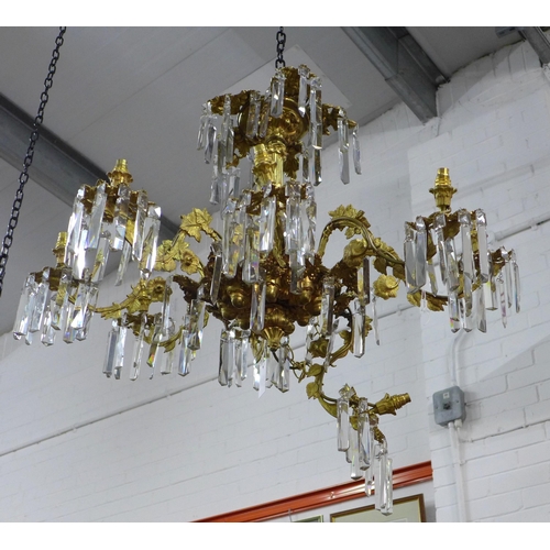 452 - Gilt metal eight branch chandelier, decorated in grape leaves, with glass drops, approximately 50 x ... 