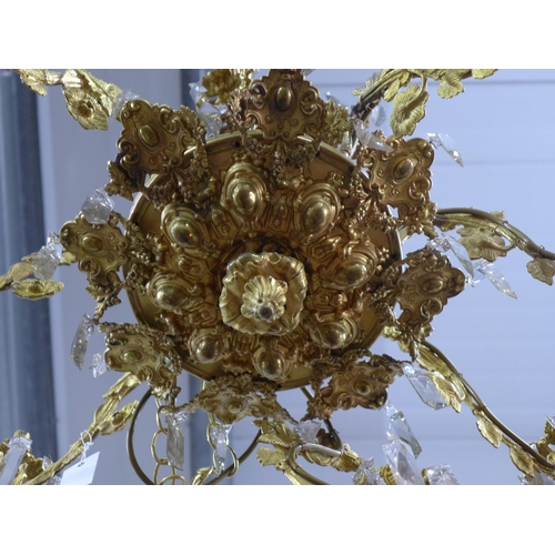 452 - Gilt metal eight branch chandelier, decorated in grape leaves, with glass drops, approximately 50 x ... 